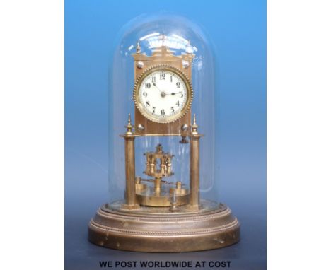 A 400 day Anniversary clock under glass dome sitting on brass base, the ivory coloured dial with Arabic numerals, 28cm tall