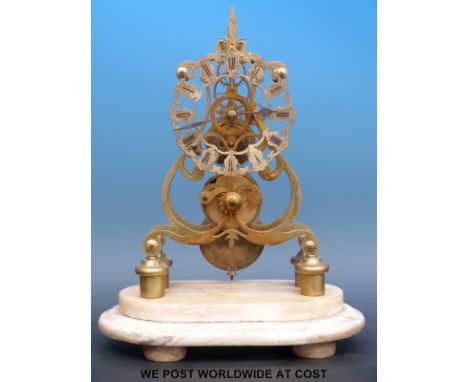 A Victorian brass skeleton clock with an eight day duration single fusee movement, black Roman numerals, sitting on marble ba