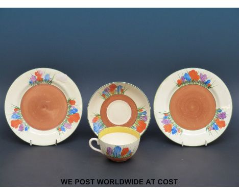 A Clarice Cliff, Newport Pottery Crocus trio together with another Clarice Cliff Crocus plate