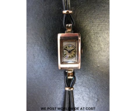 An Art Deco 9ct gold ladies wristwatch with Arabic numerals on mother of pearl effect face, case size 14x23mm.  