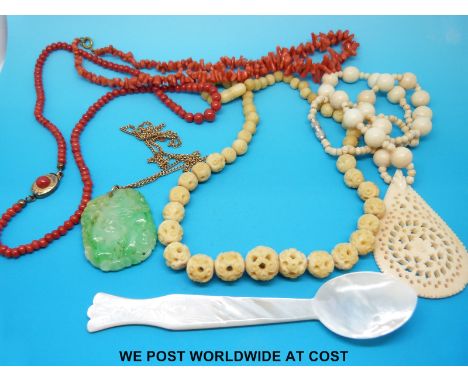 A 9ct gold chain, carved jadeite pendant, two coral necklaces, bone necklace, mother of pearl spoon etc 