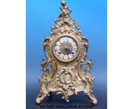 A Dutch style mantel clock in a Rococo brass ormolu style case, the dial having inlaid enamel numerals and pierced hands, put