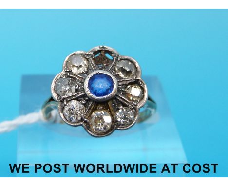 A Victorian 18ct gold ring set with a sapphire surrounded by diamonds (size K)