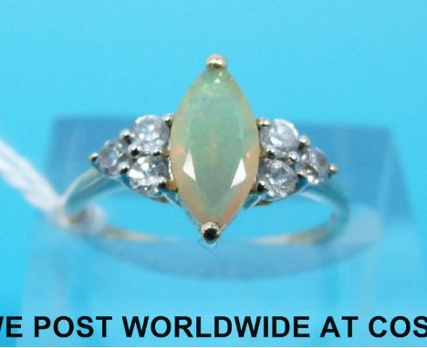 A 9ct gold ring set with an opal flanked by white sapphires (size L)