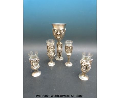 Four Lord of the Rings shot glass goblets to include Galadriel, an Orc, a Hobbit and Strider together with a goblet of Gollum
