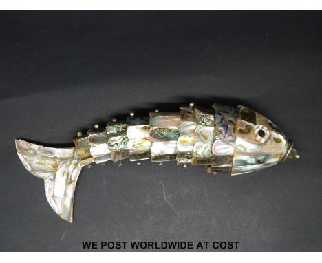 A mother of pearl and abalone fish with reticulated body and storage compartment to mouth