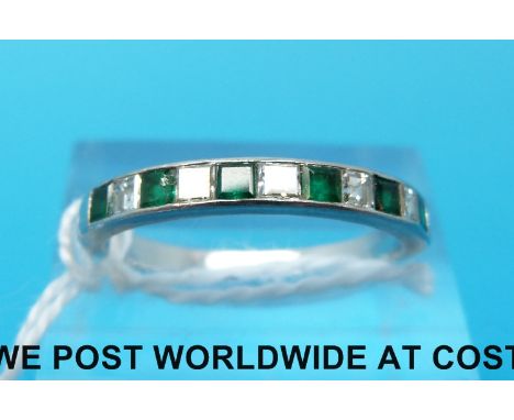 A platinum ring set with alternating square step cut emeralds and diamond (size P)