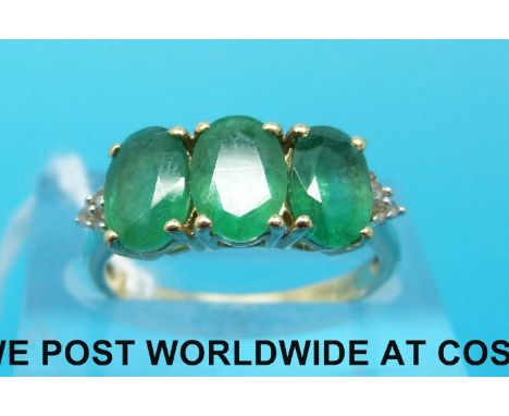 A 9ct gold ring set with three oval cut emeralds (size K)