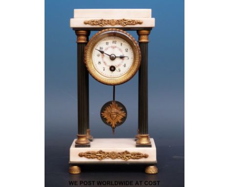 A French marble mounted clock with sunburst pendulum and floral and foliate dial decoration, 23cm tall