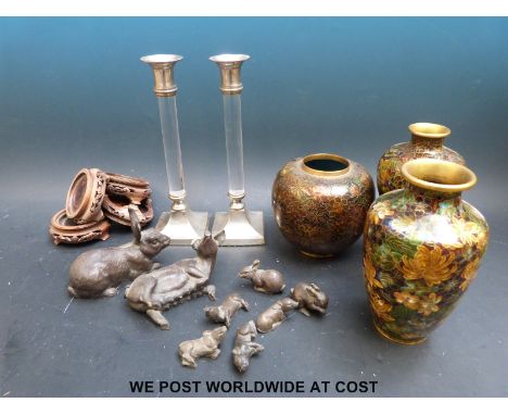 A pair of silver plated candle sticks with acrylic columns, three cloisonne vases and cold cast bronze models of rabbits and 