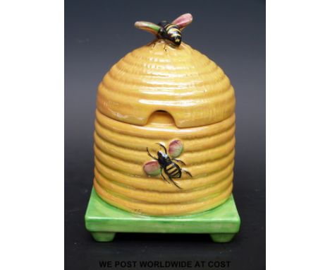 A Carltonware honey pot in the form of a hive with bee finial lid