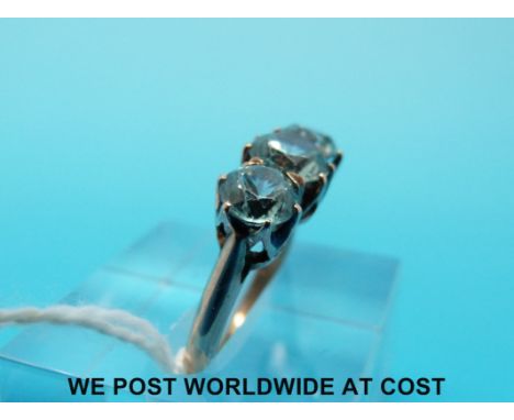 A yellow metal ring set with three round cut blue zircons (size K) 
