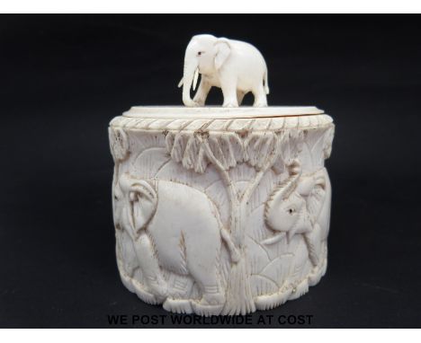 An ivory tea caddy, trinket box or powder case with elephant finial and elephants to body (height 10.5cm)