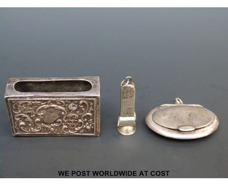 A hallmarked silver matchbox holder, small silver compact and a cigar cutter