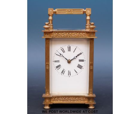 A gilt-cased late 19thC / early 20thC carriage clock with white enamel dial and pierced panels