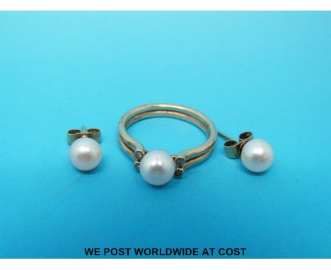 A 14ct gold ring set with a pearl and four diamonds with matching earrings