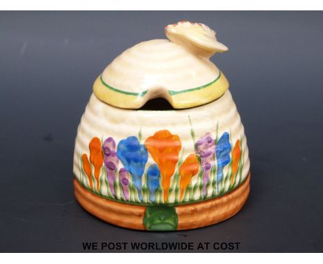 A Clarice Cliff Crocus pattern honey pot with bee finial (7cm tall)
