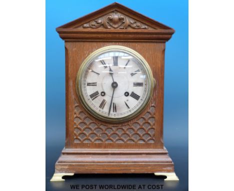 An oak cased mantel clock raised on brass bracket feet, shooting star trade mark to movement, striking on a gong, 37.5cm tall