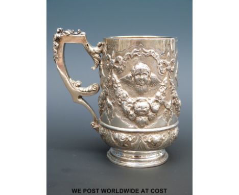 A Victorian hallmarked silver tankard with embossed decoration, London 1886, maker Army & Navy Cooperative Society Ltd., heig