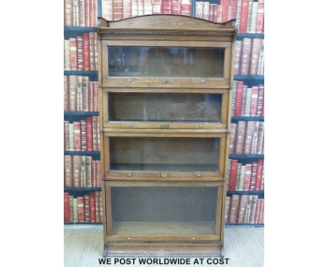 An oak Globe Wernicke style five section bookcase with up and over doors (width 88cm, depth 38cm, height 173cm)