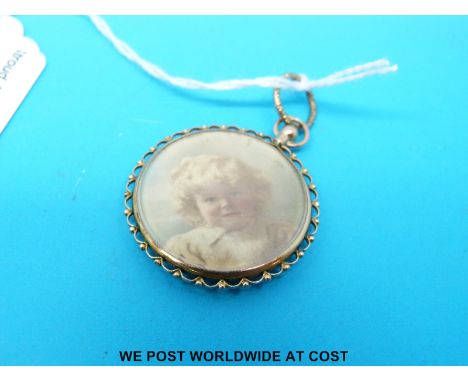 A 9ct gold mount with a portrait miniature of a young girl by Florence set between two pieces of bevelled glass
