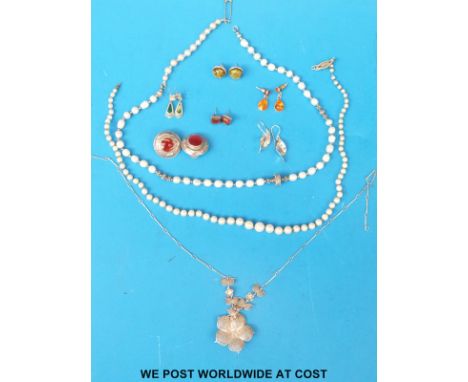 A single strand of pearls with a 9ct gold clasp set with a diamond, another pearl necklace, silver earrings set with amber an