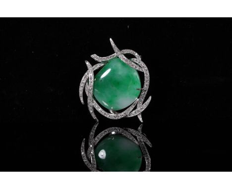 Jade and diamond brooch, the irregular white green jade cabochon within a branched white metal mount set with rows of small d