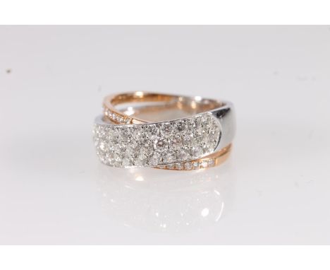 18ct white and yellow gold two tone crossover diamond ring, the plain bands set with rows of pave set round cut brilliant dia