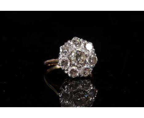 Large diamond cluster ring of flower head form, the central 1.0ct stone encircled by seven 0.15-0.2ct stones, 2ct gross, ring