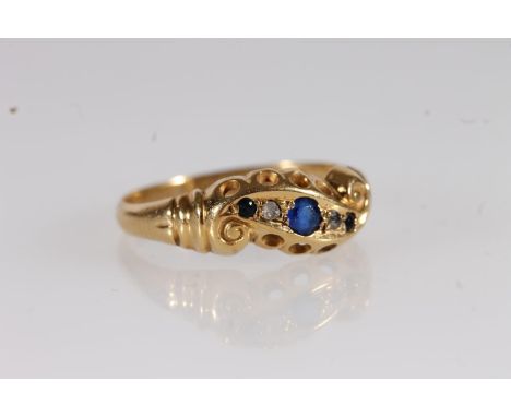 c1920s 18ct gold and sapphire crossover ring, the three sapphires interspersed by diamond chips on scrolled mount, ring size 