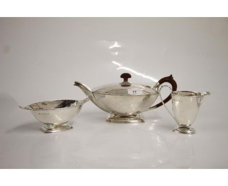 Art Deco three piece silver tea set, of typical geometric symmetrical shape, the teapot with moulded bakelite handle and fini