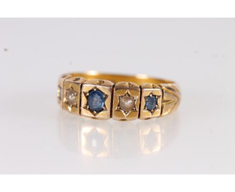 Late Victorian 15ct gold ring set with sapphires and seed pearls in a star cut mount with repeating engraved arrow shoulders 