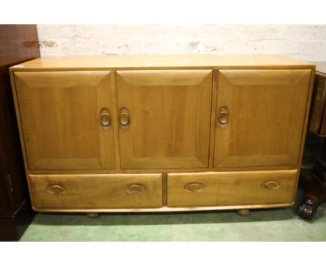 Ercol Windsor model 468 elm sideboard, c1960s, having a twin door cupboard alongside a single door cupboard with drawer, abov