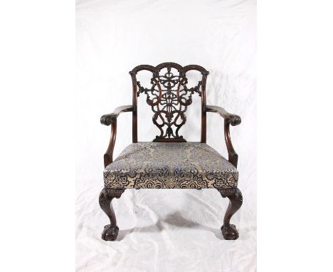 Victorian Chippendale style mahogany low elbow chair, having a pierced and carved splat, scrolled arms with padded seat, rais