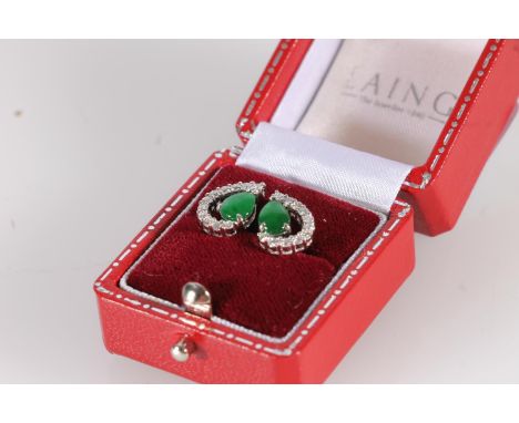 Pair of 18ct white gold jade and diamond stud earrings, the pear shape jade cabochons framed within a half surround of 11 rou