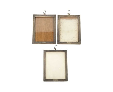 A set of seven George V silver rectangular photograph frames, with engine turned decoration, and suspension loops to the top,