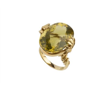 A yellow quartz single stone dress ring by Esther Eyre, the oval fancy-cut yellow quartz framed by vine leaves and tendrils, 