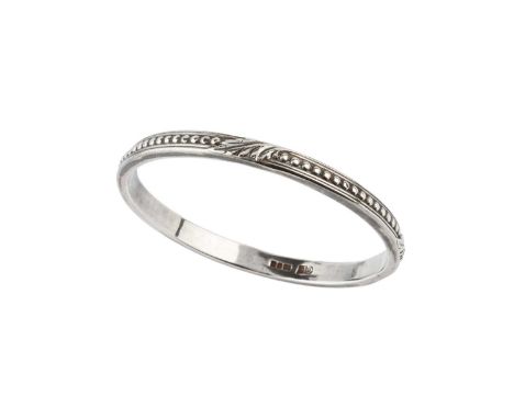 A silver slave bangle by the Guild of Handicraft, designed as a continuous frieze of beads and foliage, with reeded borders, 