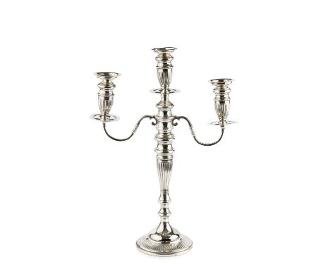 A George V silver three light candelabrum, the detachable branches with lobed sconces, on lobed and knopped column and circul