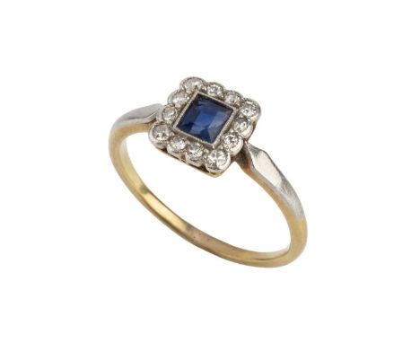 A sapphire and diamond cluster ring, the rectangular step-cut sapphire millegrain collet set within a border of single-cut di