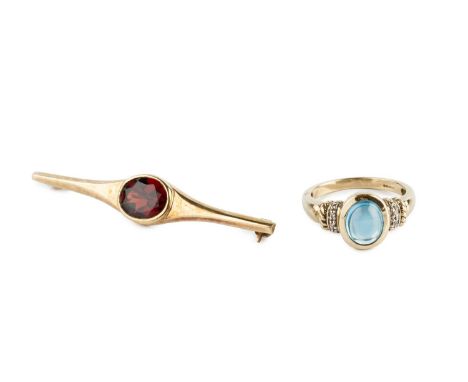 A gem set dress ring, the oval cabochon blue stone in collet setting, between single-cut diamond set shoulders, 9ct gold moun