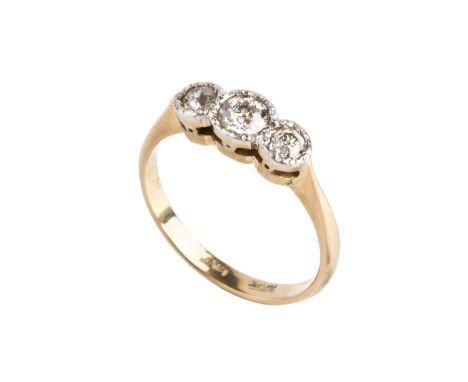 A diamond three stone ring, the graduated old-cut diamonds in illusion settings, two colour precious metal mounted, total dia