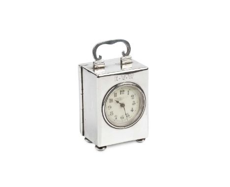 A late Victorian silver small carriage timepiece, with circular enamel dial, the plain rectangular case with hinged top handl