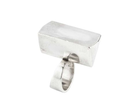 An abstract silver dress ring designed by Astrid Fog for Georg Jensen, the hollow three dimensional panel designed as a trian