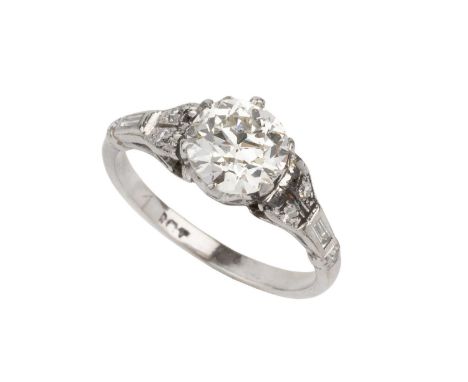 A diamond single stone ring, the old brilliant-cut diamond in six claw setting, between single and baguette-cut diamond set s