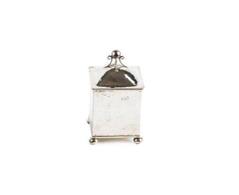 A silver Arts &amp; Crafts square section tea caddy, with planished decoration, the domed hinged cover with ball and scroll f