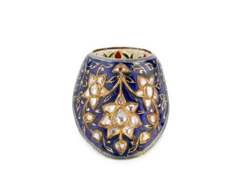 An Indian enamel and diamond set archer's ring, the shaped mount applied with a trio of flowerhead clusters of lasque-cut dia