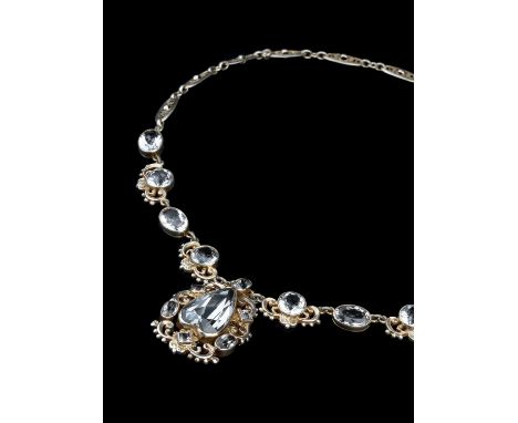 An Arts and Crafts rock crystal pendant necklace attributed to Sybil Dunlop, of stylised scrolled design with bead accents, t