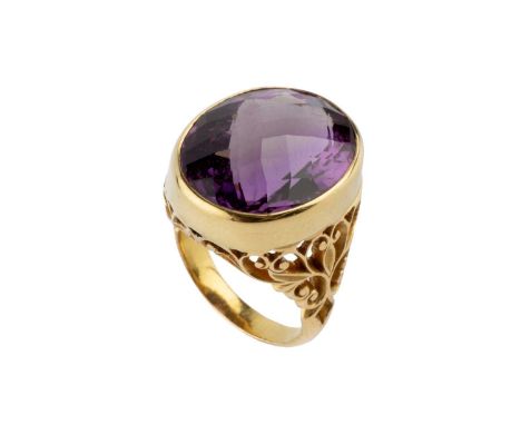 An amethyst single stone dress ring, the oval fancy-cut amethyst in collet setting, above a scroll pierced gallery and should