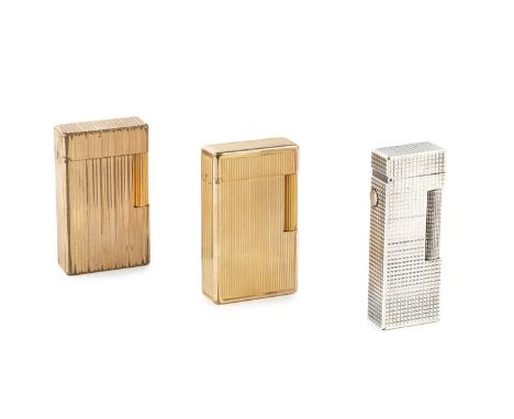 A silver plated lighter by Dunhill, of rectangular form with textured decoration, 6.5cm high, boxed, and two gold plated ligh